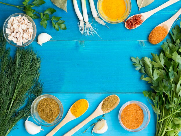 Top view wooden spoons full of spices