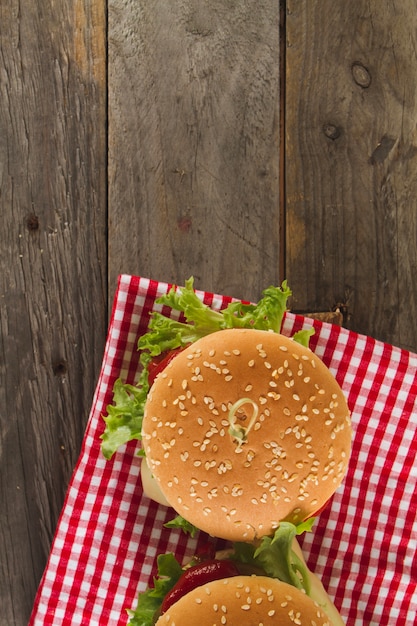 Top view of wooden surface with appetizing burgers