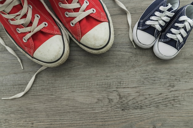 Free photo top view of wooden surface with red and blue shoes