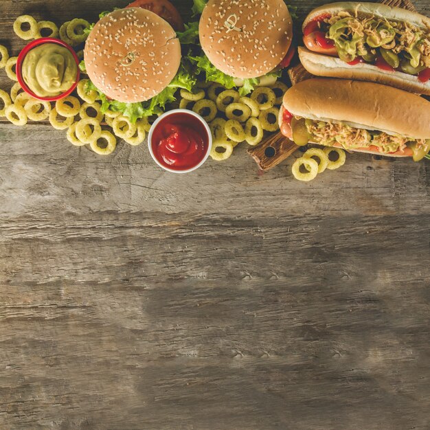 Top view of wooden surface with tasty fast food