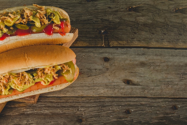 Top view of wooden surface with two appetizing hot dogs