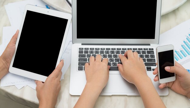 Top view of workers using different digital devices