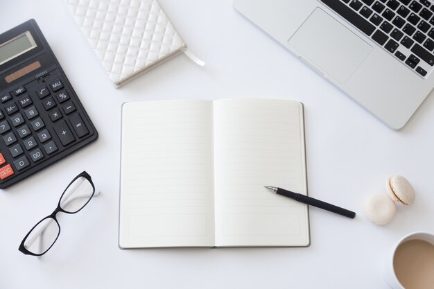 Top view of a working desk with open notebook