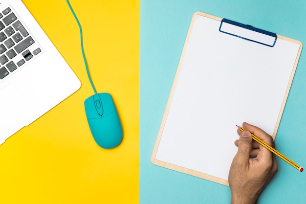 Top view workspace concept with blank clipboard