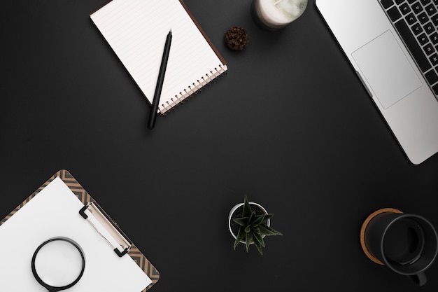 Top view of workspace with notebook and notepad