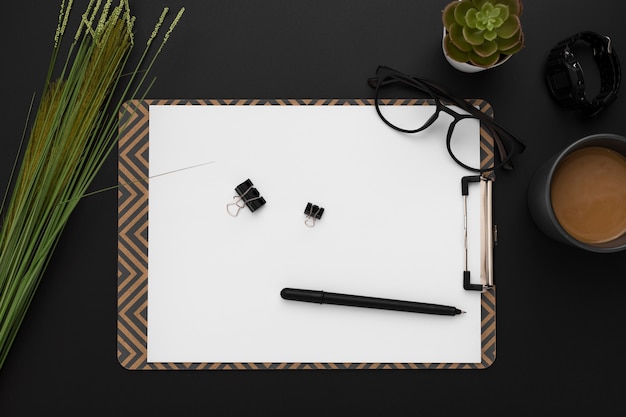 Top view of workspace with notepad and succulent plant