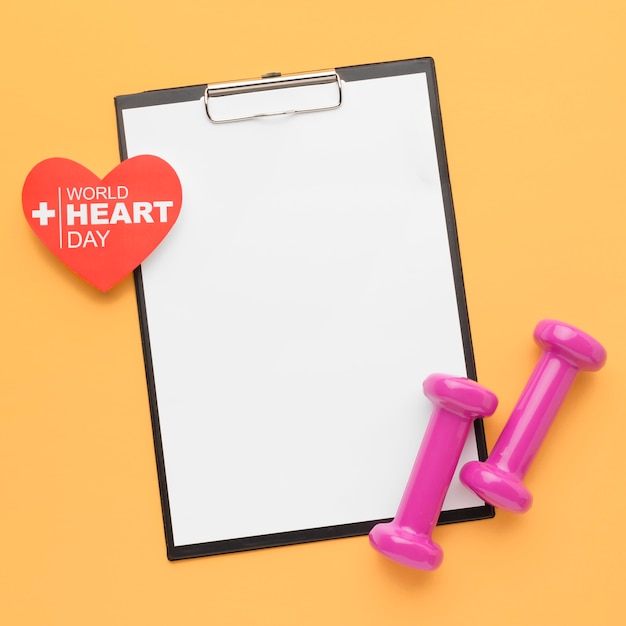 Top view world heart day concept with clipboard