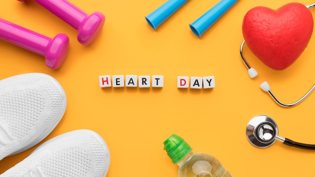 Top view world heart day concept with sport equipment
