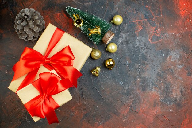 Вид сверху рождественские подарки золотые рождественские шары мини-рождественская елка на темно-красном столе с копией пространства