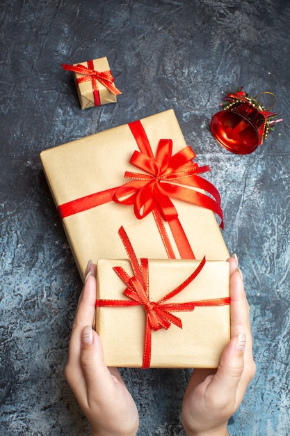 Top view xmas presents with red bows on light-dark background