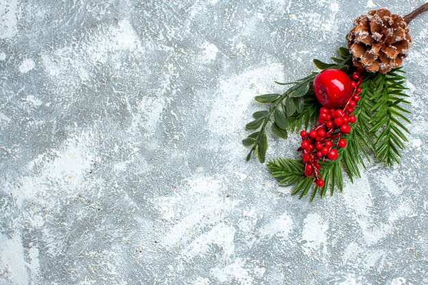 Top view xmas red berry cone on grey white table copy space