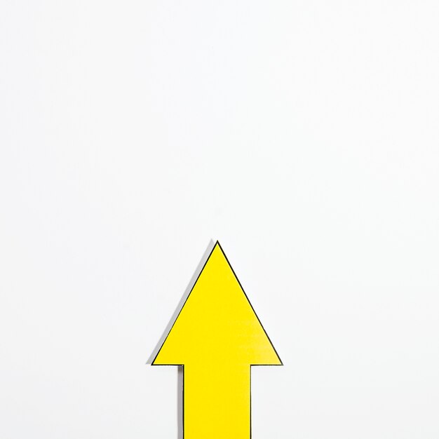 Top view of yellow arrow with copy space