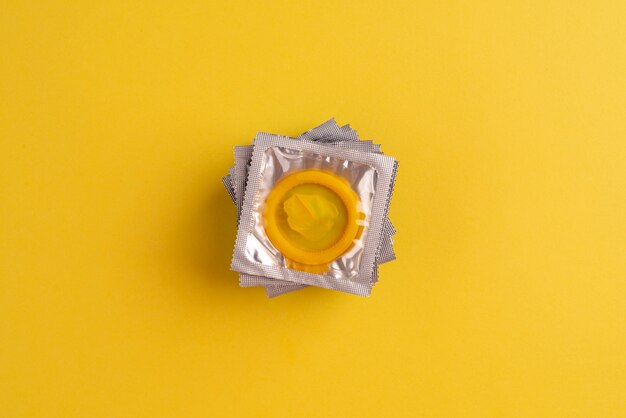 Top view yellow condoms arrangement
