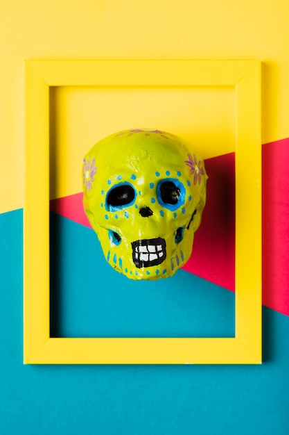 Free photo top view yellow frame with yellow skull