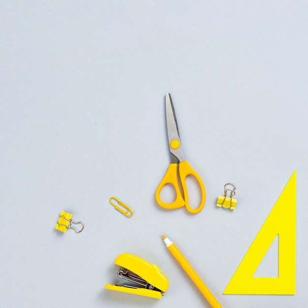 Top view yellow office supplies 