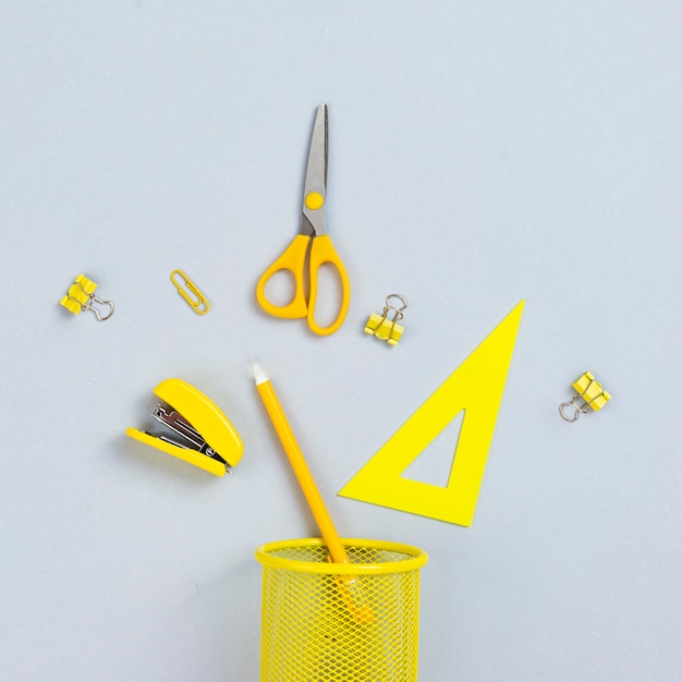 Top view yellow office supplies 