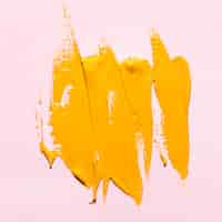 Free photo top view of yellow paint brush strokes on surface