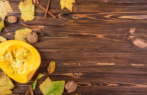 Top view yellow pumpkin and walnuts with copy space