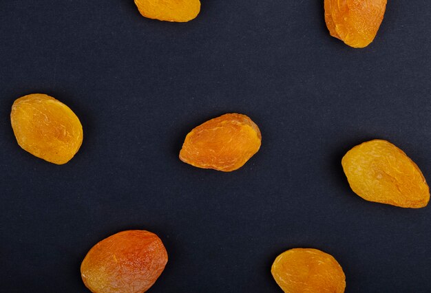 Top view of yellow raisins isolated on black background