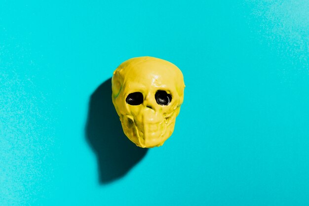 Top view yellow skull on blue background