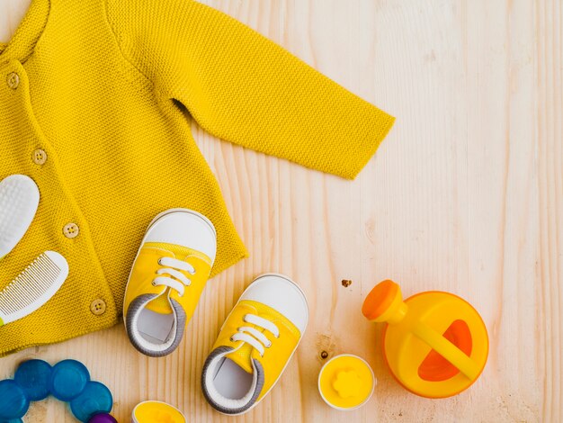 Top view yellow sweater with toys