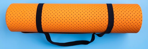 Top view yoga mat on blue background