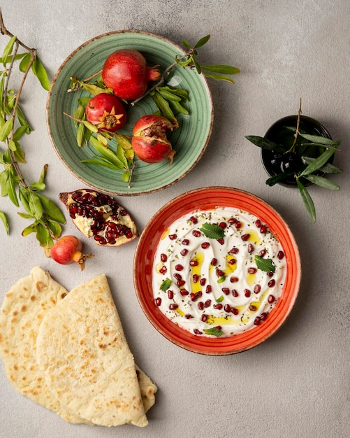 Top view of yogurt with pomegranate and oil