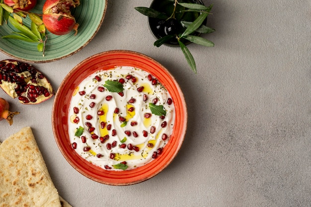 Free photo top view of yogurt with pomegranate and oil