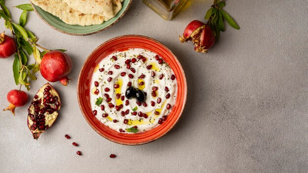 Top view of yogurt with pomegranate and oil