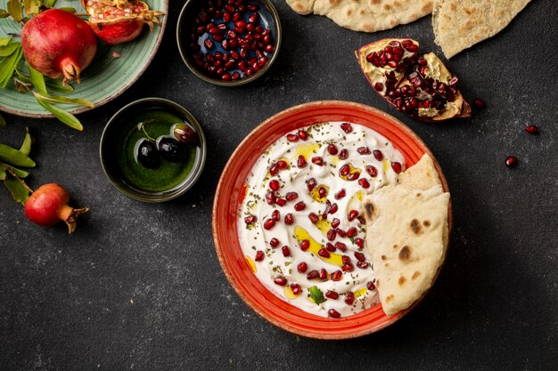 Top view of yogurt with pomegranate and oil