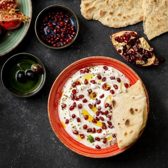 Top view of yogurt with pomegranate and oil