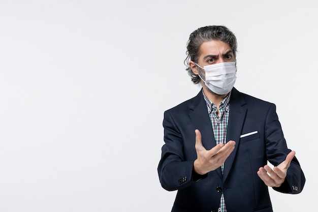 Free photo top view of young businessman in suit wearing mask and confused on something on white surface