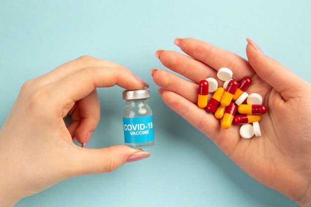 top view young female with pills in her hands on blue background pandemic covid- virus health color lab science hospital