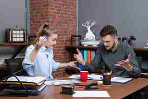 Free photo top view of young funny office team confused on one issue in office enviroment