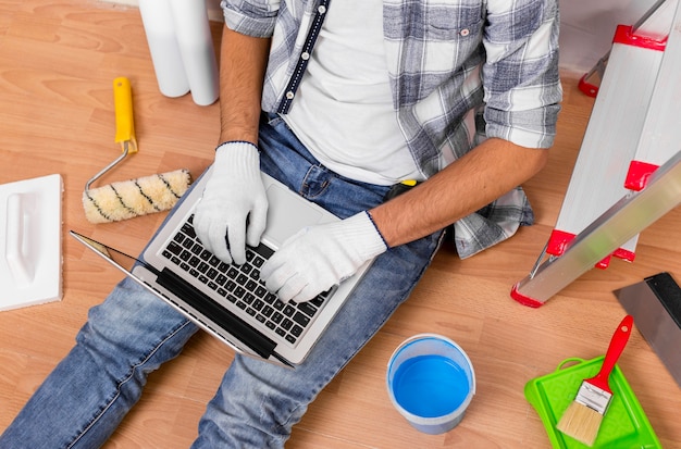 Free photo top view of young man holding a laptop