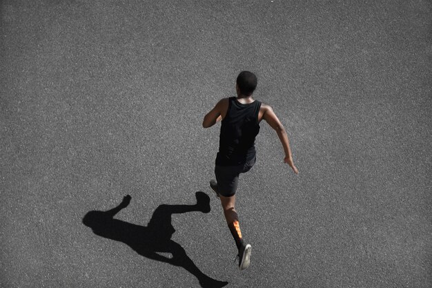 Top view of young man jogging