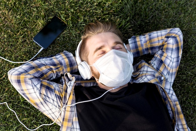 Free photo top view young man with face mask relaxing