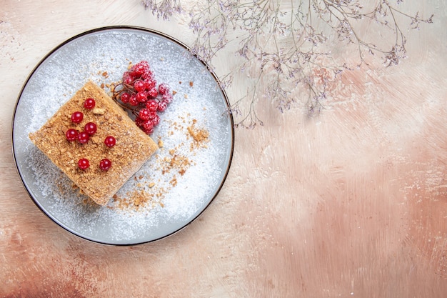 Top view yummy cake slice with red berries on light