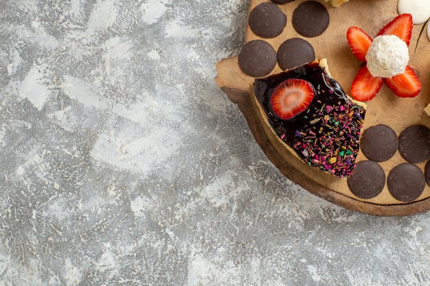 Foto gratuita fette di torta gustosa vista dall'alto con biscotti al cioccolato sulla superficie bianca