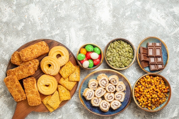 Free photo top view yummy cakes with candies and cookies on the white background