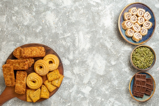 Free photo top view yummy cakes with candies and cookies on white background