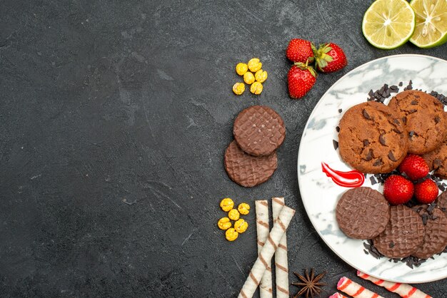 Top view yummy choco biscuits for tea on a dark background sweet cookie sugar tea