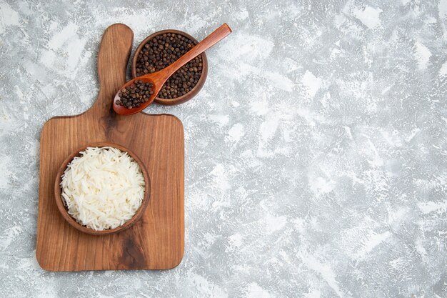 Top view yummy cooked rice with pepper on a white