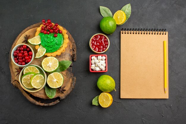 Top view yummy creamy cake with fruits on dark background sweet biscuit cookie