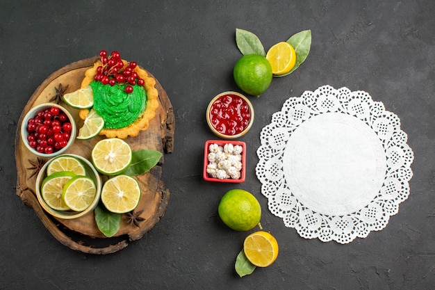 Top view yummy creamy cake with fruits on dark background sweet biscuit cookies