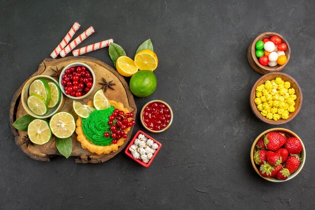 Top view yummy creamy cake with fruits on dark background sweet cookie biscuits