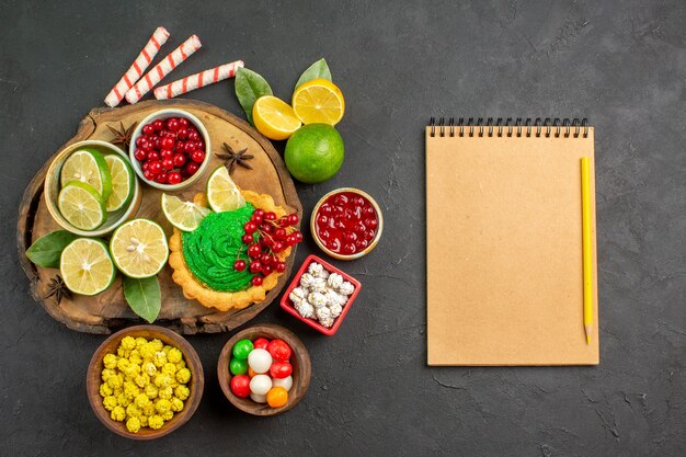 Top view yummy creamy cake with fruits on dark-grey background sweet biscuit cookie