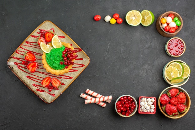 Top view yummy creamy cake with fruits on grey background dessert color biscuit sweet