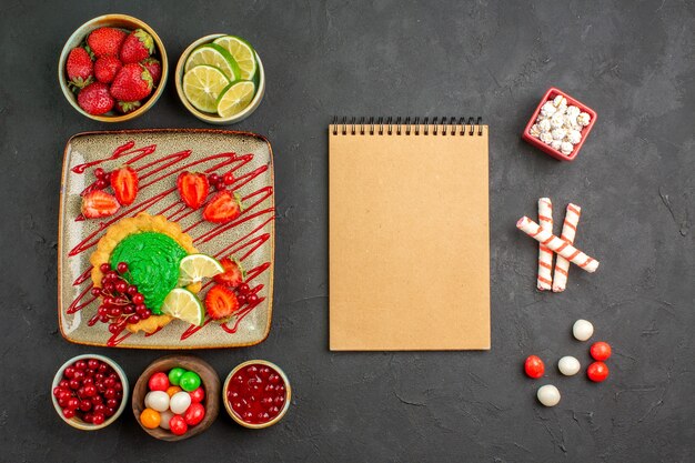 Top view yummy creamy cake with fruits on grey background dessert cookie biscuit sweet