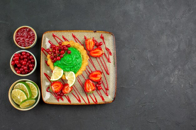 Top view yummy creamy cake with strawberries on dark background sweet tea sugar dessert